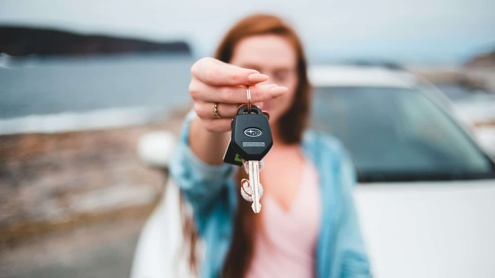 Conductrice tendant les clés de son véhicule avant la restitution en fin de contrat LOA ou LLD